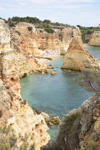 Rock formations by sea against sky