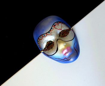 Close-up of mask against black background