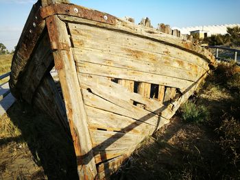 Shipwreck on field during sunny day