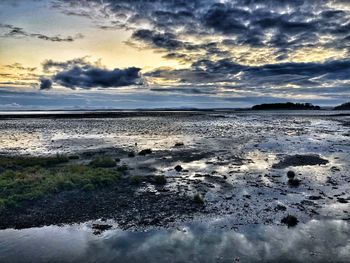 Scenic view of beach against sky during sunset