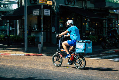 Man riding bicycle on road