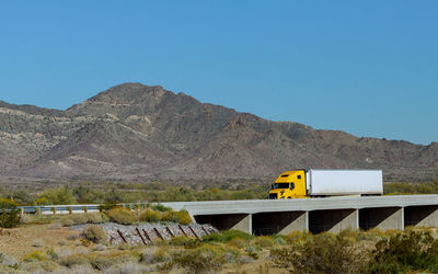 Train on mountain against clear blue sky