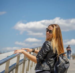 Beautiful young girl in sunglasses walks around the city person