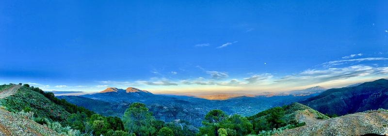 Scenic view of mountains against blue sky