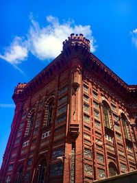 Low angle view of historical building against blue sky