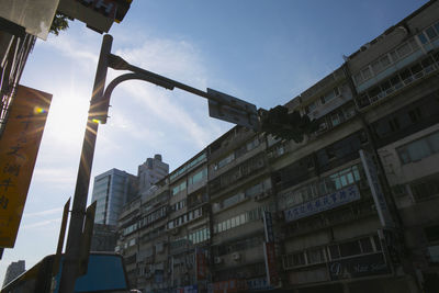 Low angle view of road signal against sky