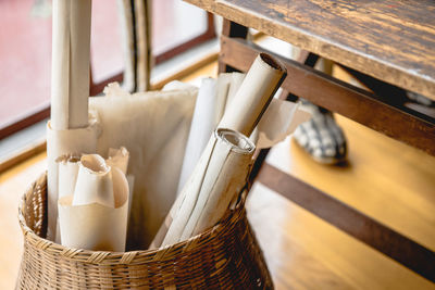 High angle view of folded papers in wicker container at home