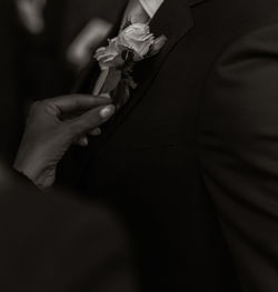 Midsection of man holding flower