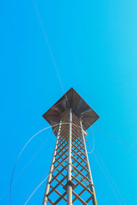 Low angle view of lookout tower against clear blue sky