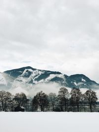 Scenic view of snow covered mountains against sky