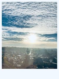 Aerial view of buildings in city against sky