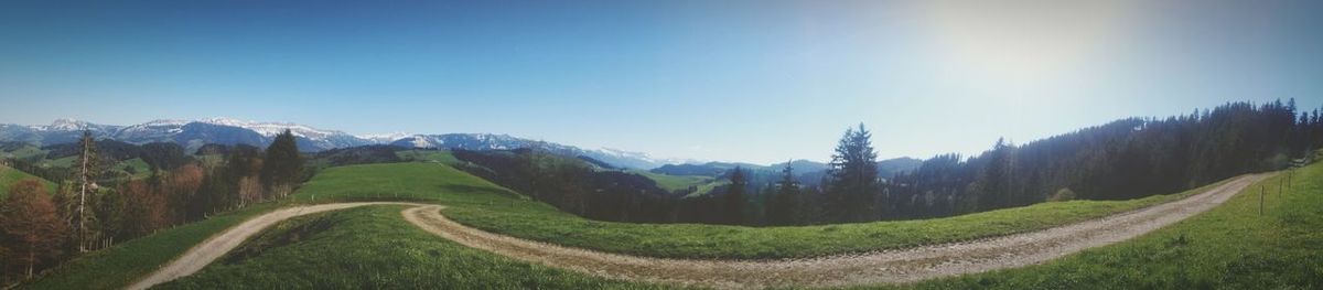 Panoramic shot of country road along landscape