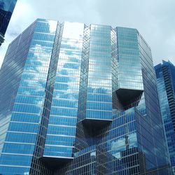 Low angle view of modern glass building in city