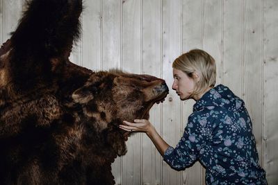  woman touching bear taxidermy