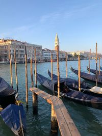 View of wooden posts in canal