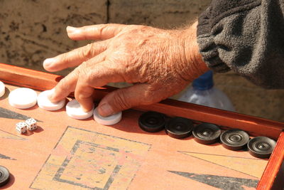 Close up  of a man's hand in backgamoon game