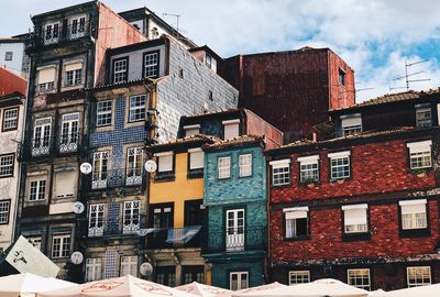 Low angle view of buildings in town against sky