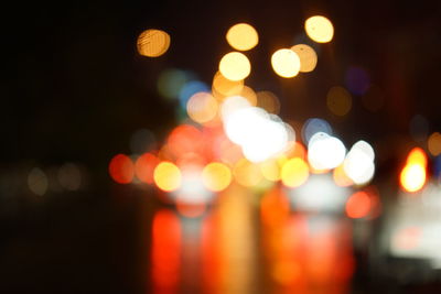 Defocused image of illuminated christmas lights at night