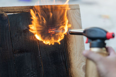 Close-up of hand holding burning fire