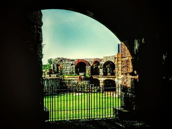 Bridge against sky seen through arch