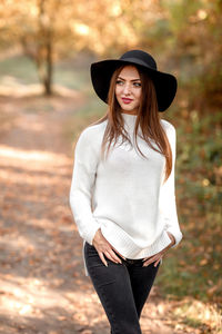 Contemplative woman wearing hat while walking at park