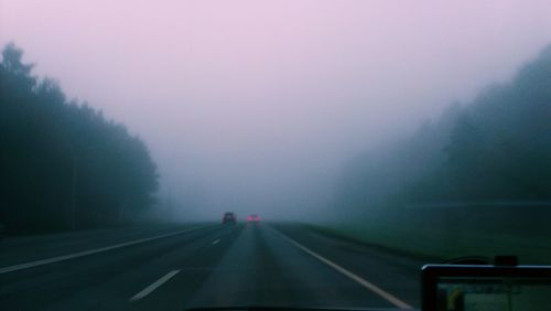 Cars on road in foggy weather