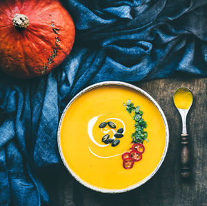 Pumpkin soup in bowl on table