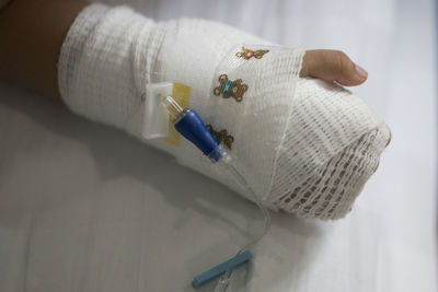 Midsection of person with bandage on hand