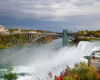 View of bridge over river against cloudy sky