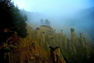 Scenic view of mountains against cloudy sky