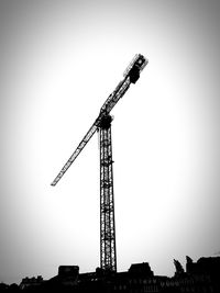 Low angle view of crane against clear sky