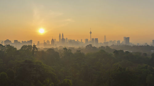 View of buildings in city during sunset