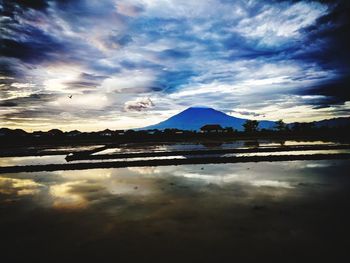 Scenic view of lake against sky during sunset