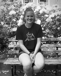 Portrait of a smiling girl sitting outdoors