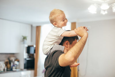 Side view of mother and daughter at home