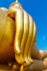 Low angle view of statue against blue sky