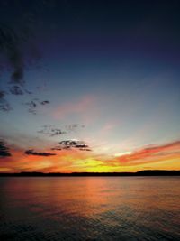 Scenic view of sea against romantic sky at sunset