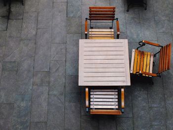 High angle view of empty chairs against wall in city