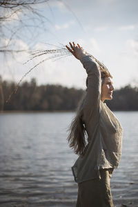 Close up authentic woman posing in front of lake in pagan outfit portrait picture