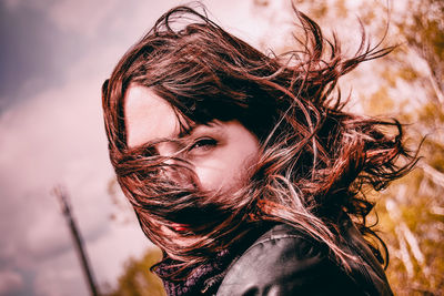 Close-up portrait of woman with tousled hair