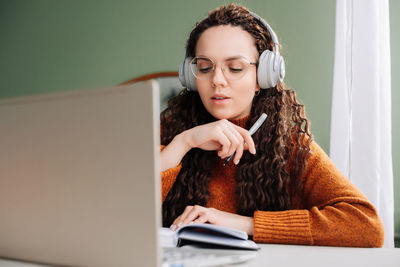 Young woman using laptop at home