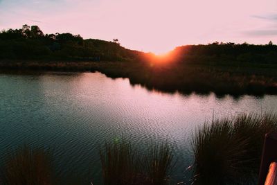 Scenic view of lake against sky during sunset