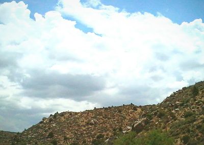 Scenic view of landscape against cloudy sky