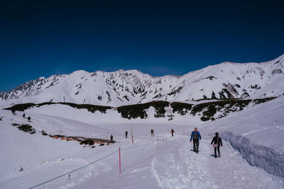 People skiing on snowcapped mountain