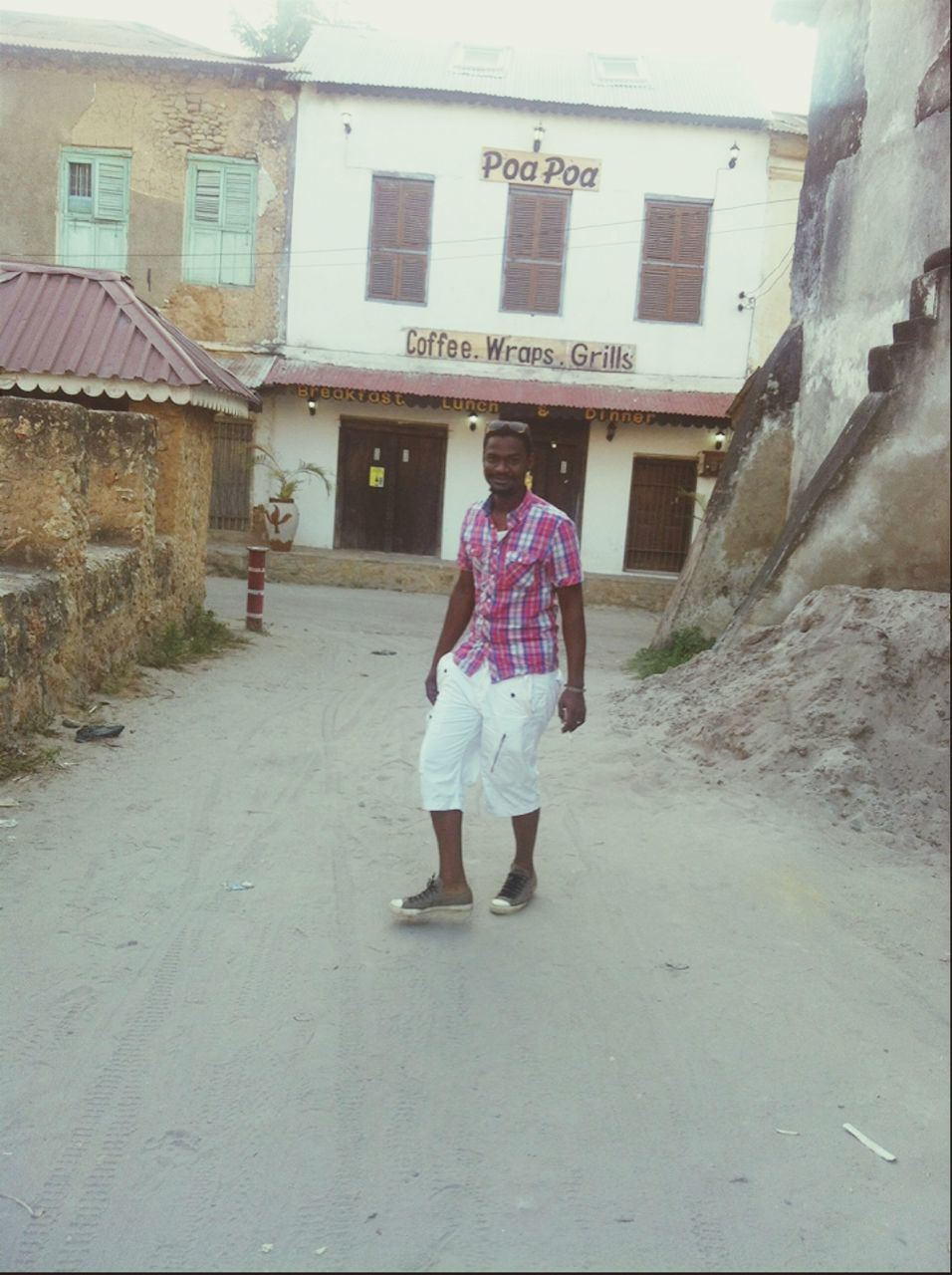 full length, rear view, building exterior, walking, architecture, built structure, lifestyles, casual clothing, street, men, leisure activity, the way forward, person, day, umbrella, outdoors, standing, road