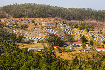 High angle view of townscape and trees on field