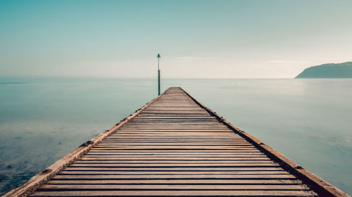 Pier over sea against sky