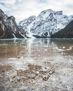 Surface level of frozen lake against mountain range