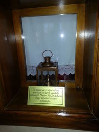 Close-up of information sign on glass table