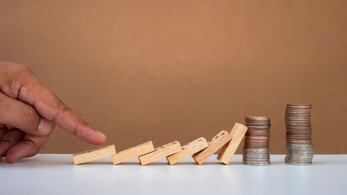 Close-up of hand holding stack of wooden table